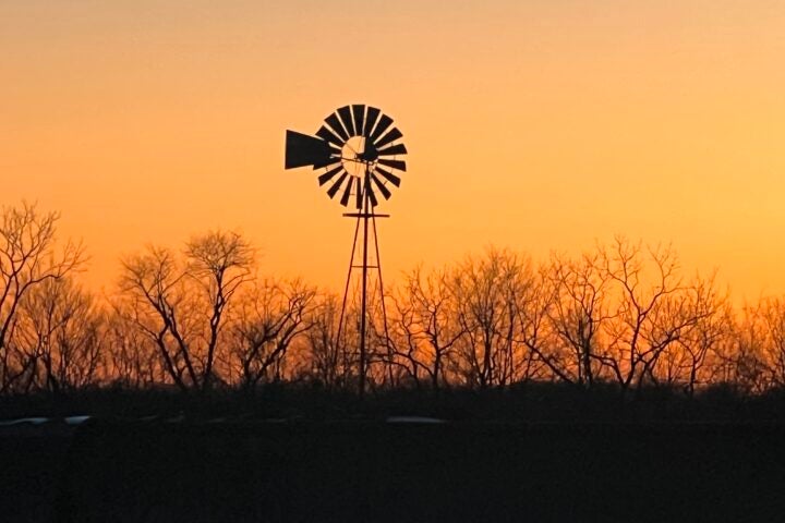 A windmill silhouette at sunrise