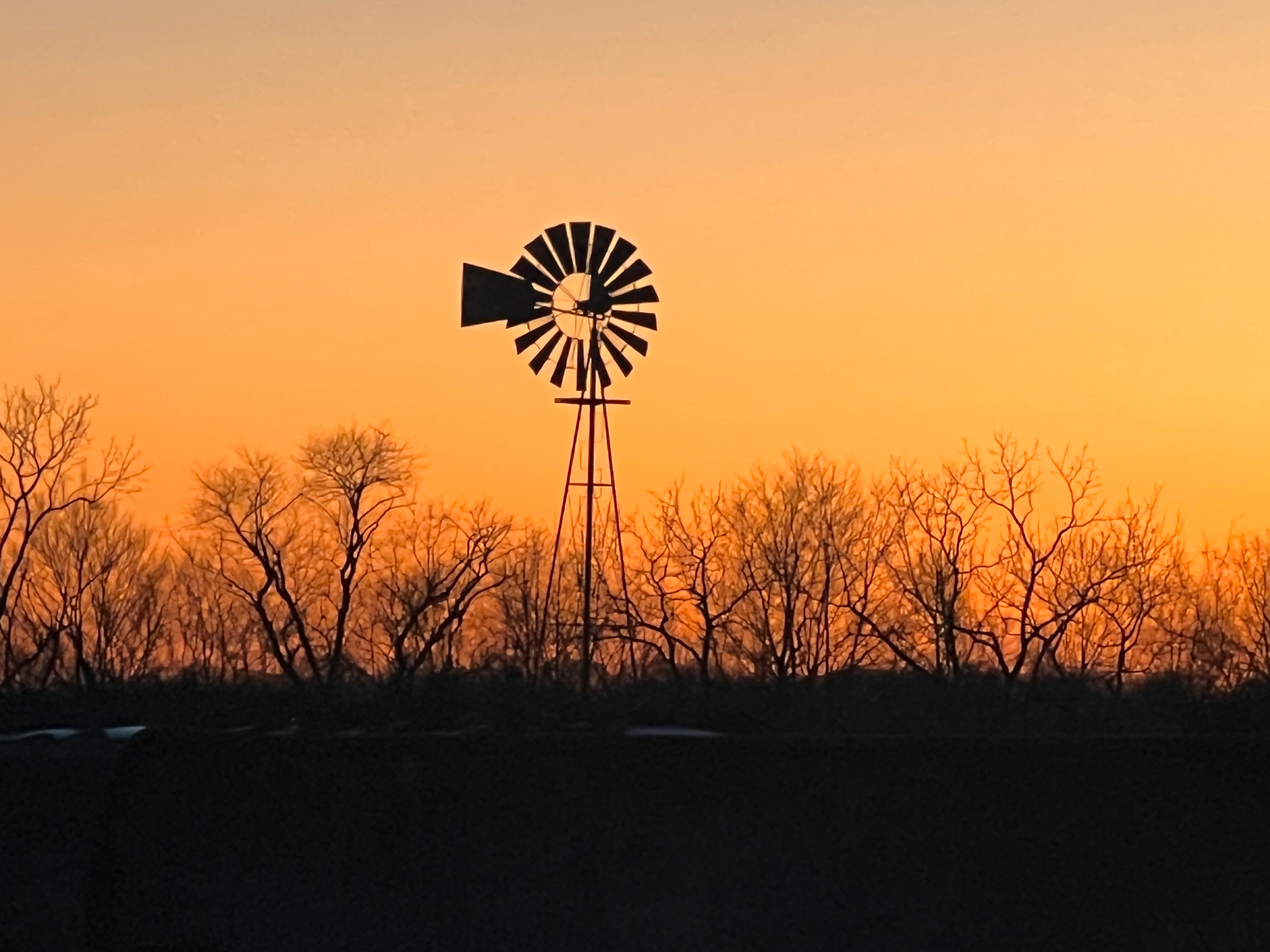 A windmill silhouette at sunrise